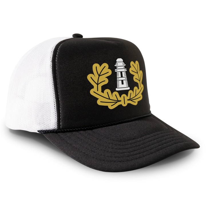 Black and white trucker hat with lighthouse emblem.