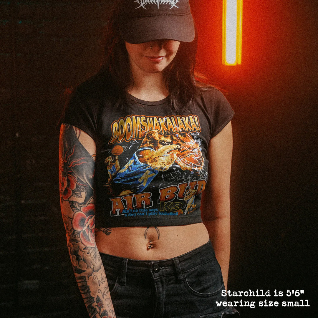 Female model wearing cropped baby tee with Air Bud graphic
