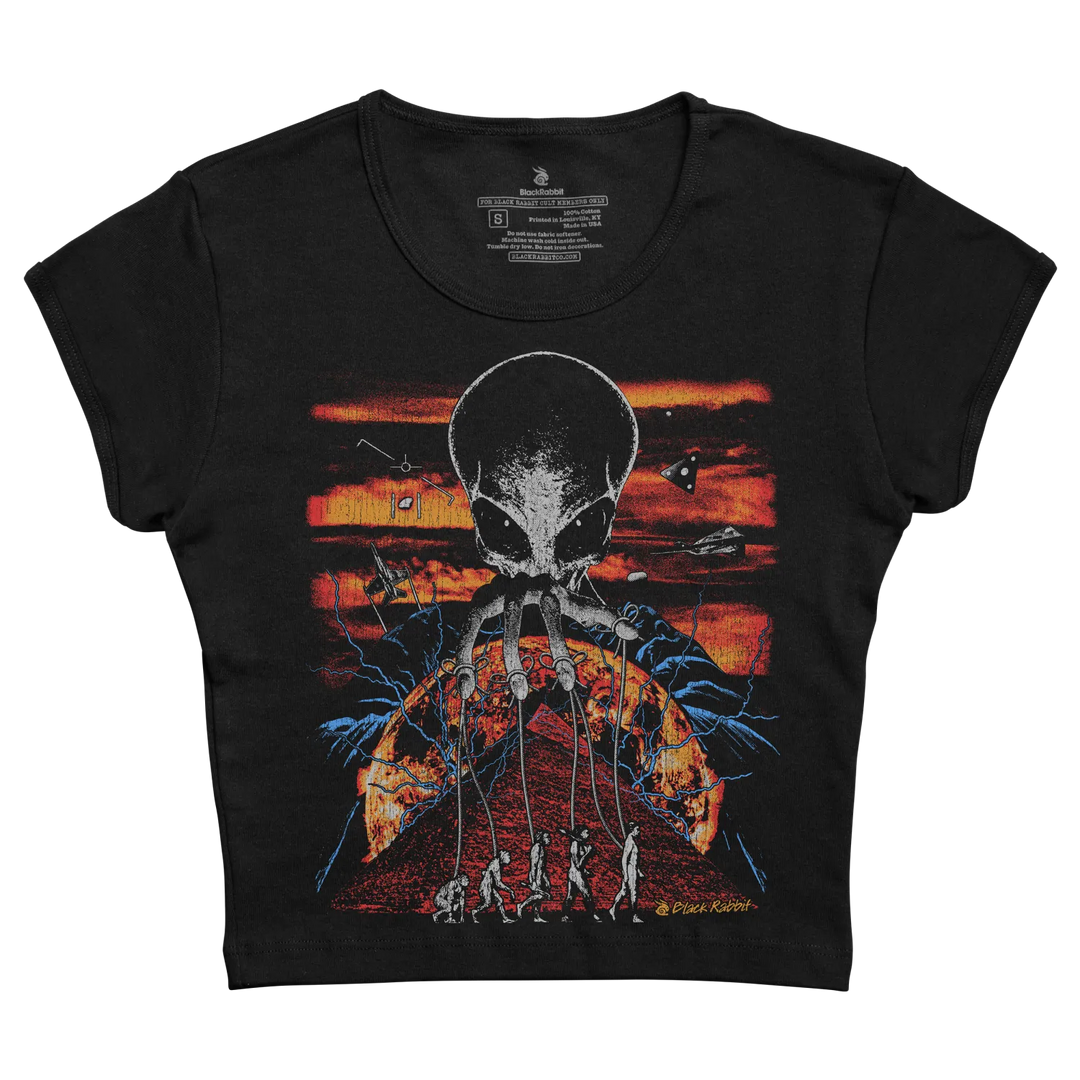 Black short-sleeved t-shirt featuring a graphic of an alien skull with tentacles holding strings to human figures against a fiery orange and red sky.