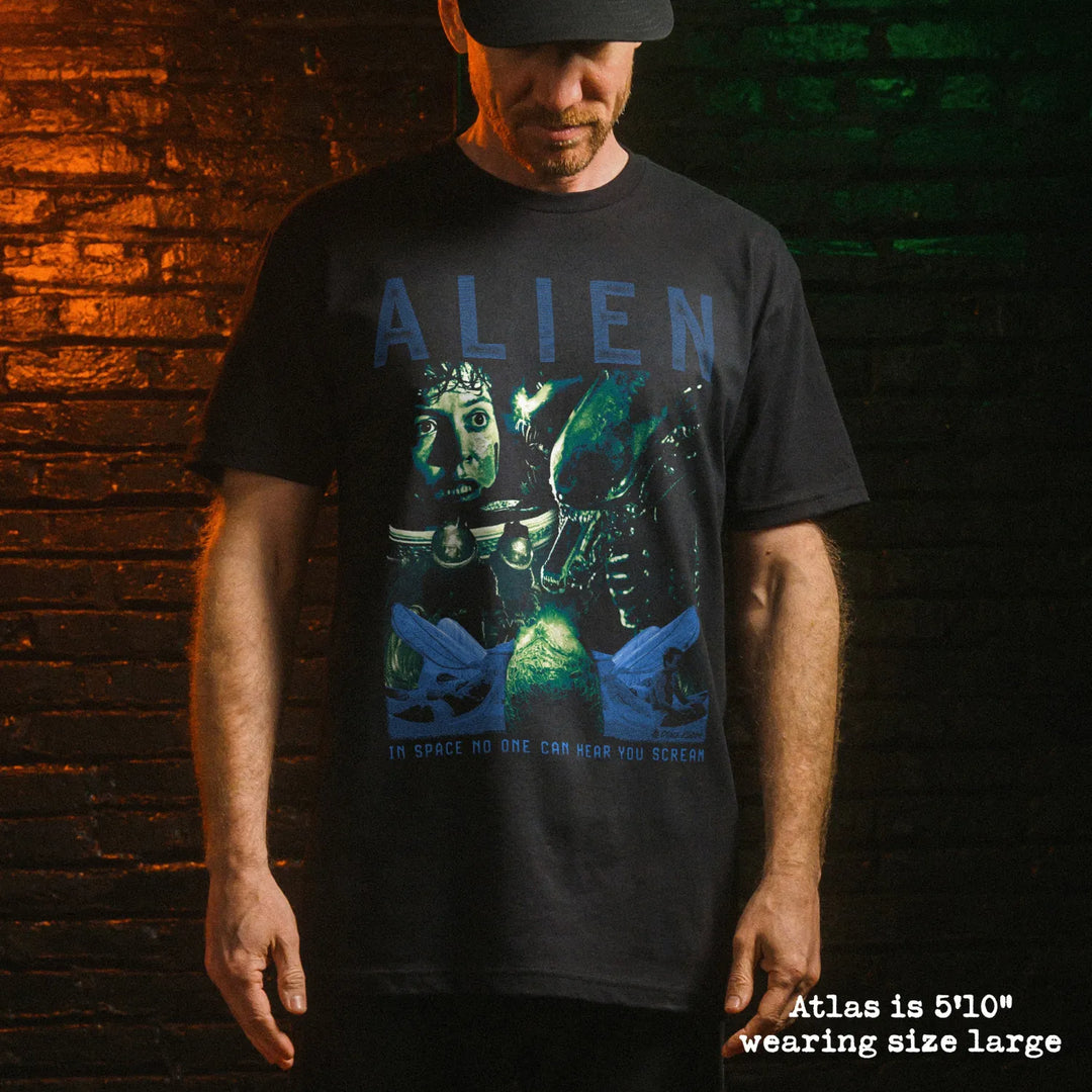 Male model wearing black premium tee with alien graphic 