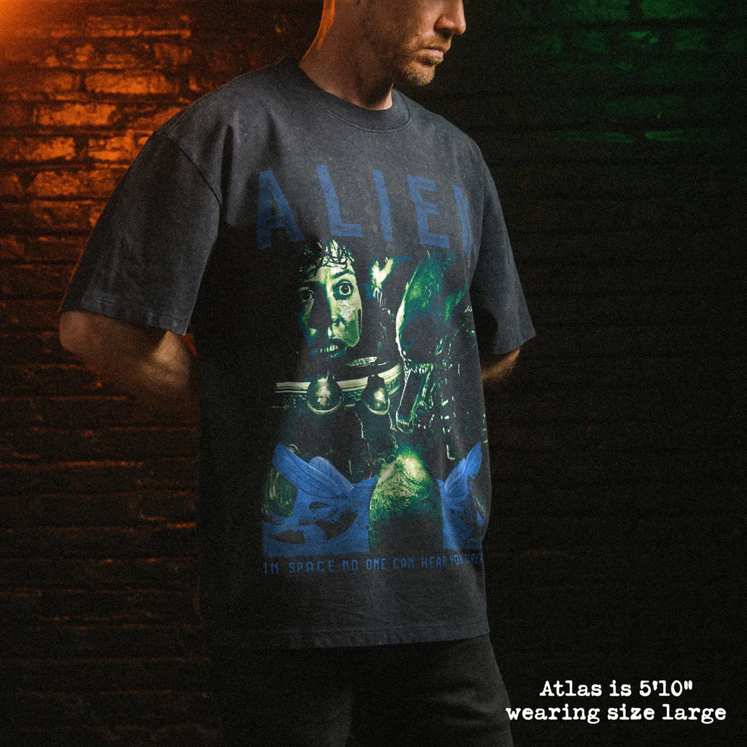Male model wearing stone washed heavy tee with alien graphic 