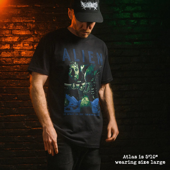 Male model wearing black premium tee with alien graphic 