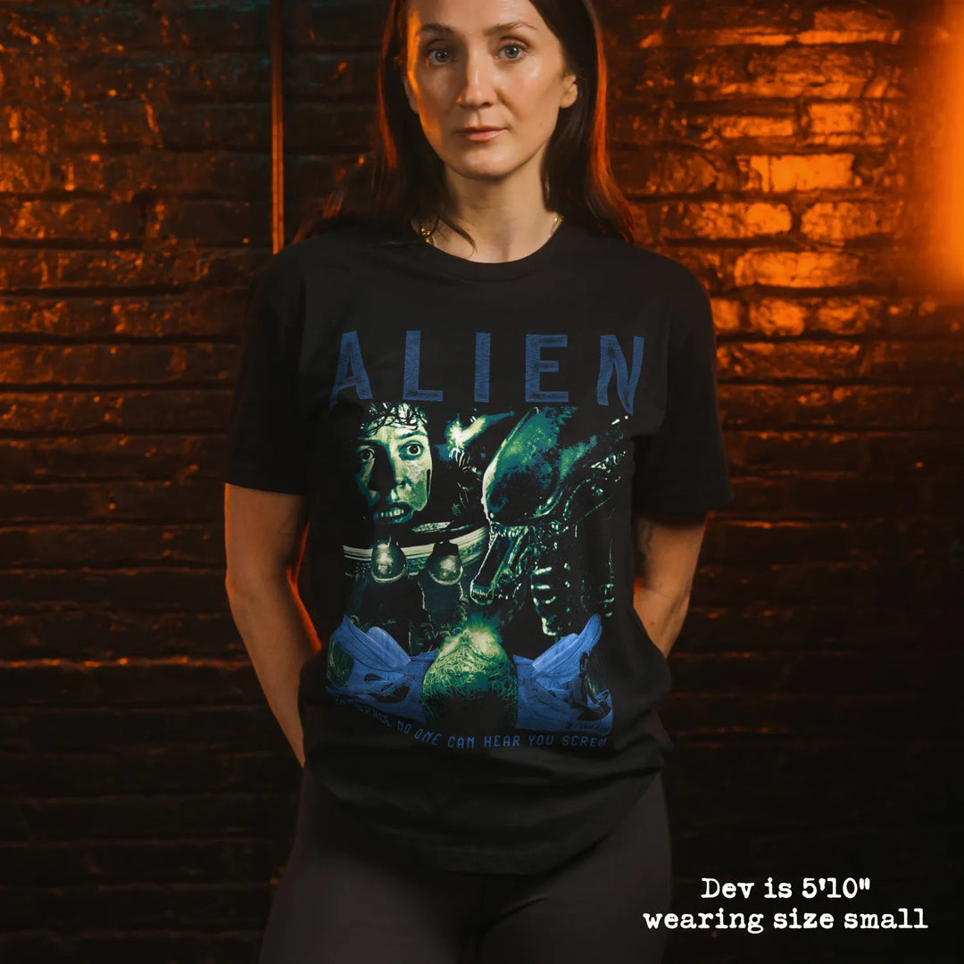 Model wearing black premium tee with alien graphic 