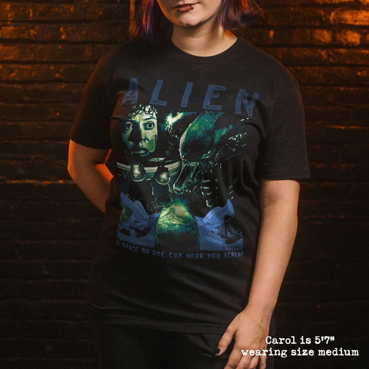 Model wearing black premium tee with alien graphic 