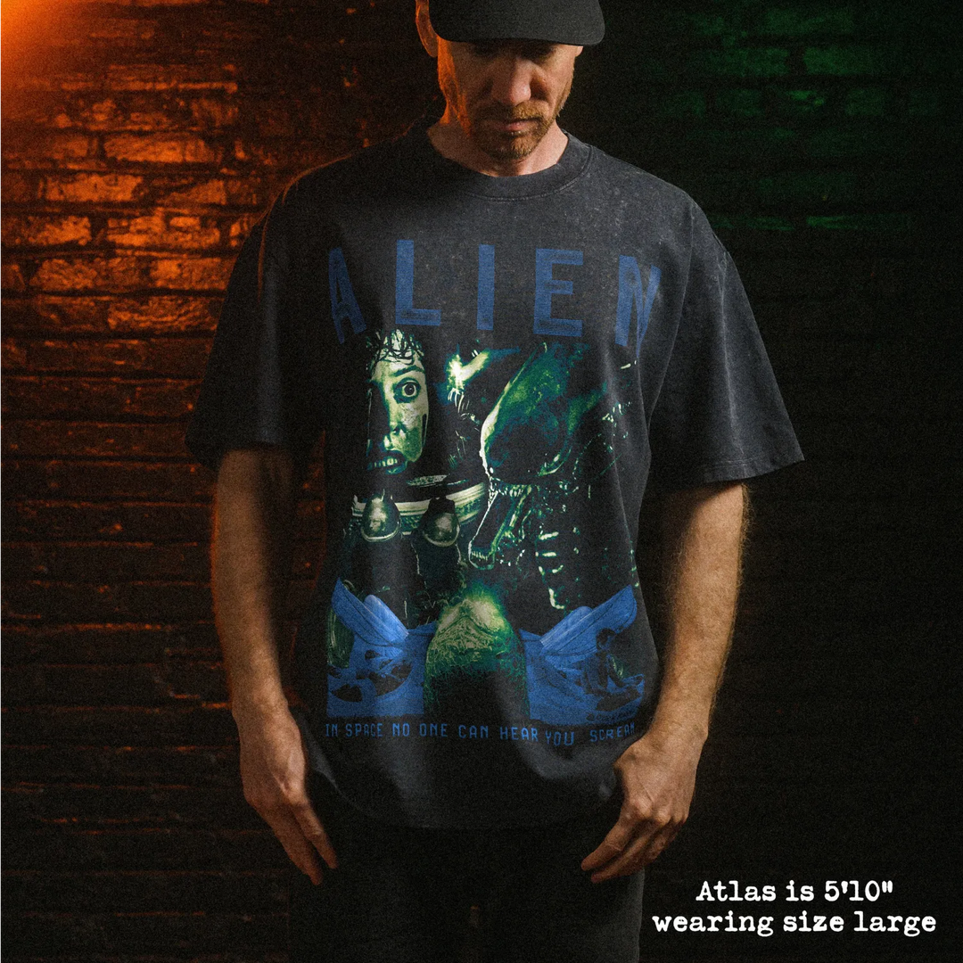 Male model wearing stone washed heavy tee with alien graphic 