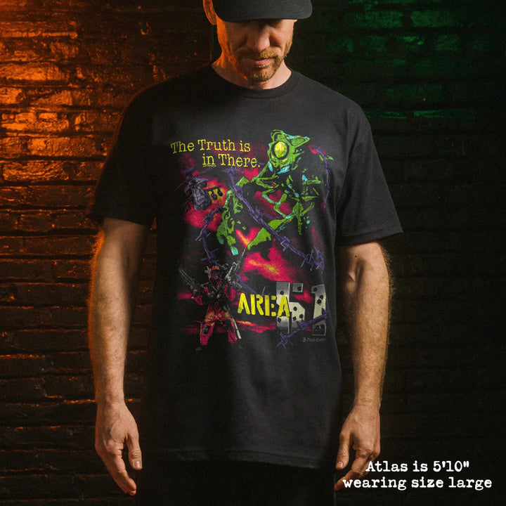 Male model wearing black premium tee with area 51 graphic 