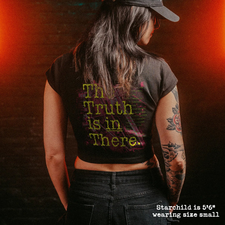 Female model wearing cropped baby tee with area 51 graphic
