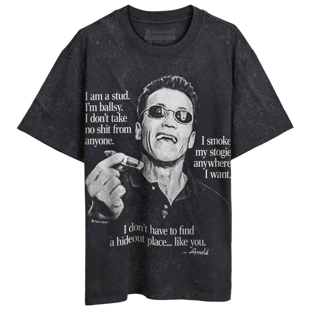 A dark grey t-shirt featuring a black and white image of Arnold Schwarzenegger wearing sunglasses and holding a cigar, with various quotes attributed to him.