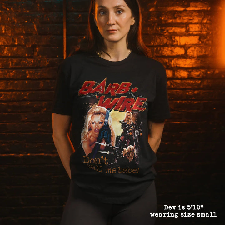 Model wearing black t shirt with Barb Wire graphic

