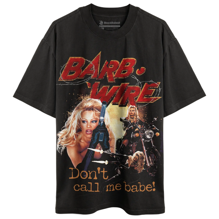 Black t-shirt with graphic design of ’barb wire’ and slogan ’don’t call me babe!’ featuring a woman holding guns.