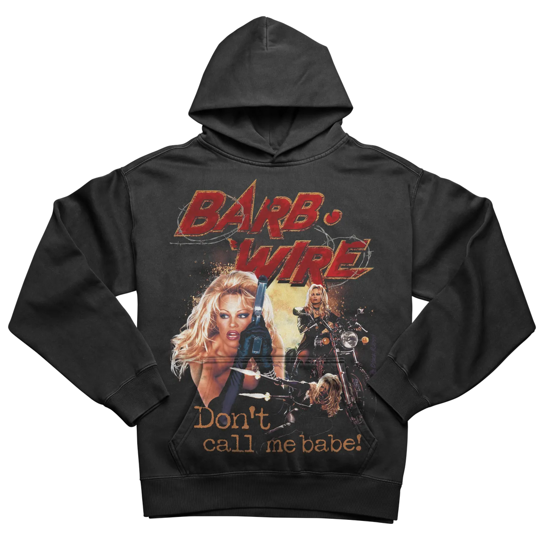 Black hoodie with graphic design of ’barb wire’ and slogan ’don’t call me babe!’ featuring a woman holding a gun.