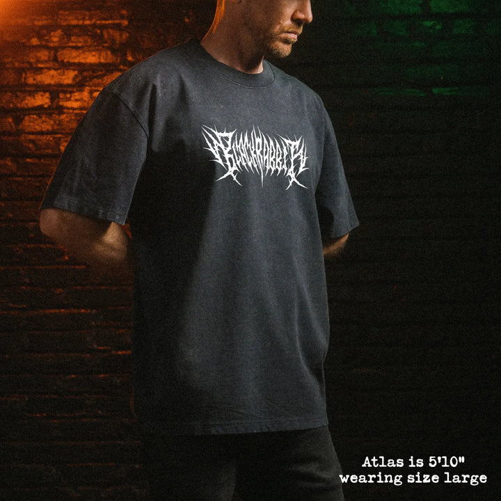 Male model wearing stone wash heavy tee with black rabbit death metal graphic 
