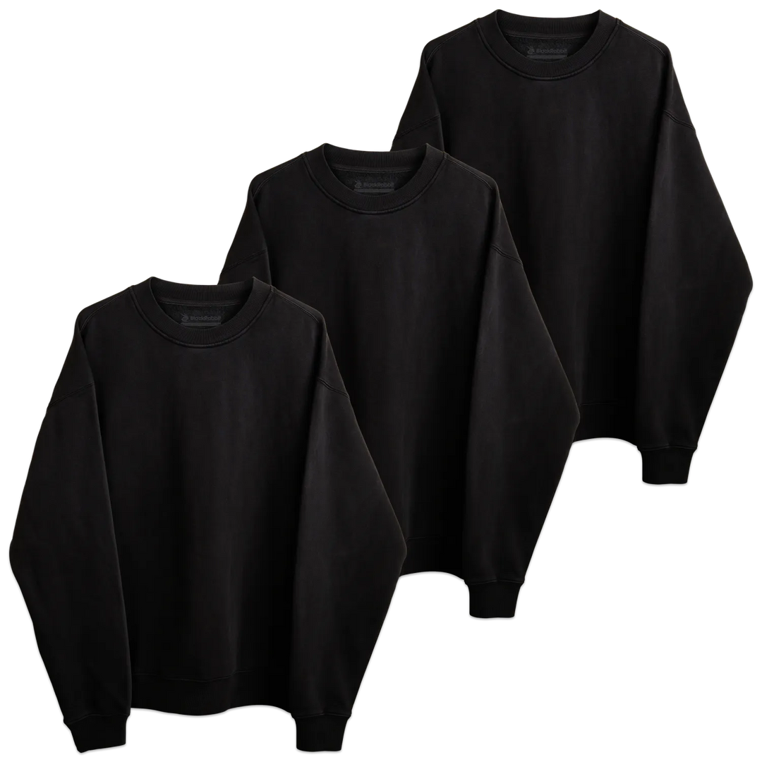 Three blank black rabbit crewneck sweatshirts in black long-sleeved cotton arranged in a tiered display