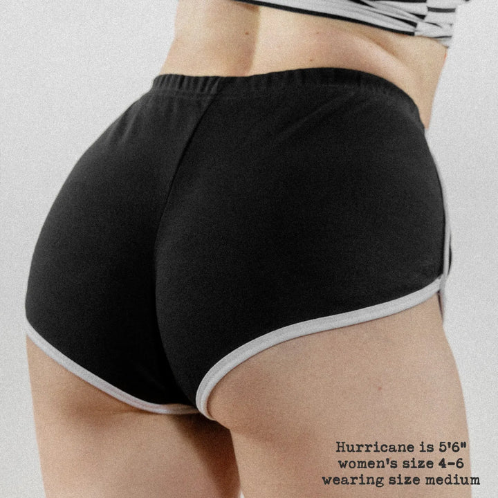 Black athletic retro sport shorts with white trim along waistband and hem from blank black rabbit women’s collection
