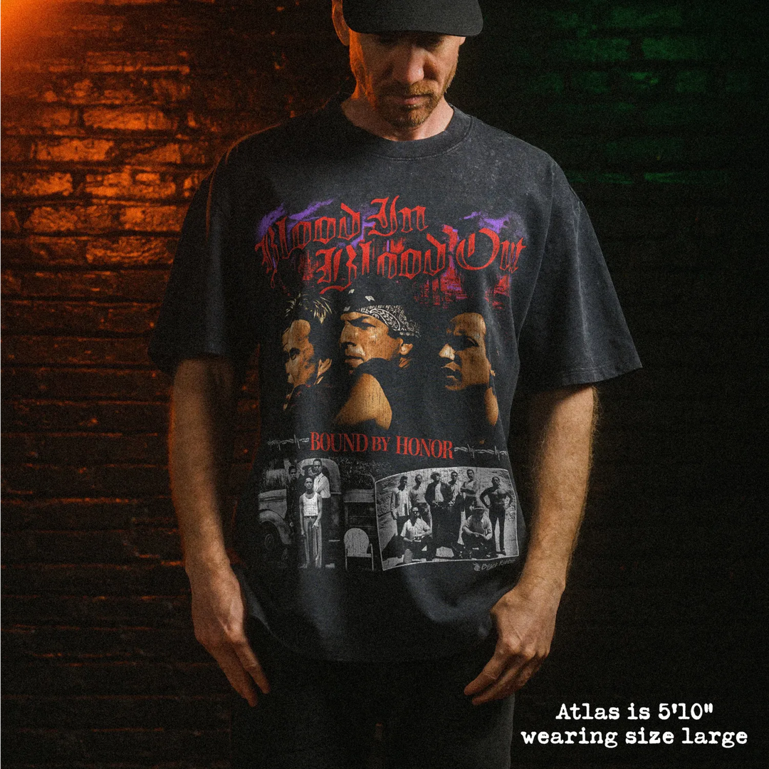 Male model wearing stone wash heavy tee with blood in blood out graphic 