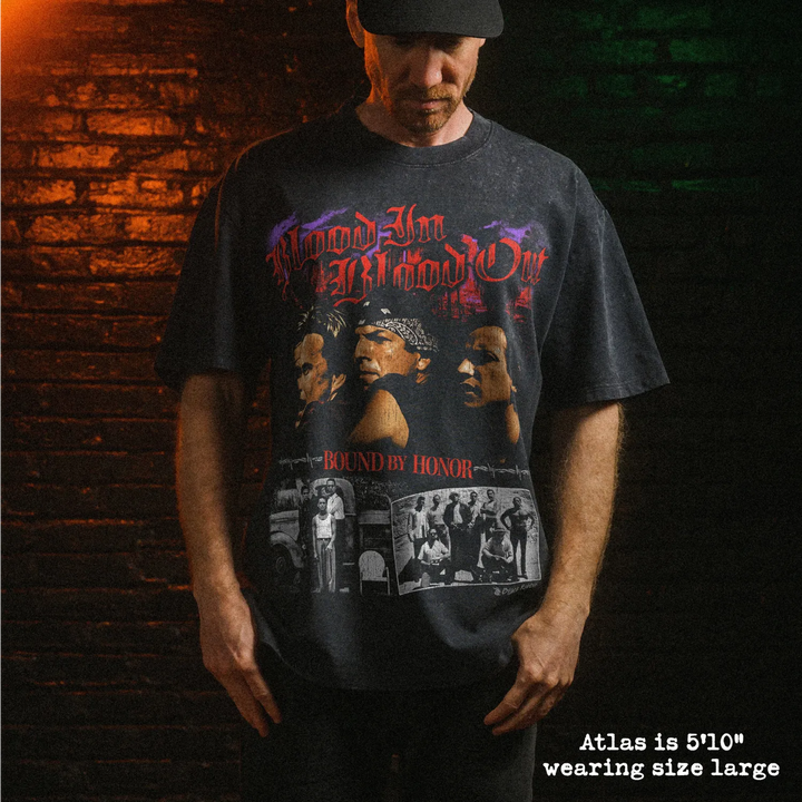 Male model wearing stone wash heavy tee with blood in blood out graphic 