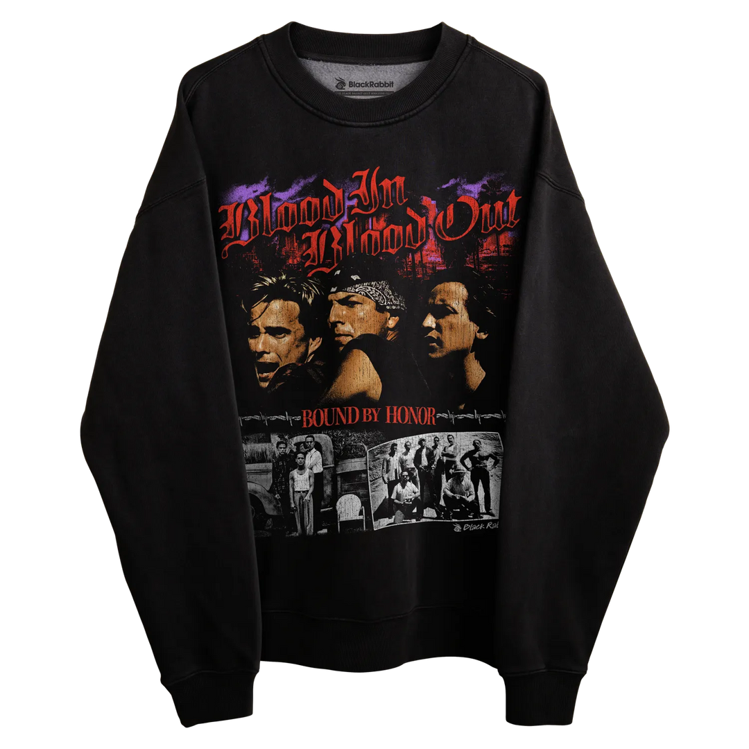 Black sweatshirt with graphic design of ’blood in blood out’ and collage featuring characters in a boxing ring, material appears to be cotton or polyester blend.