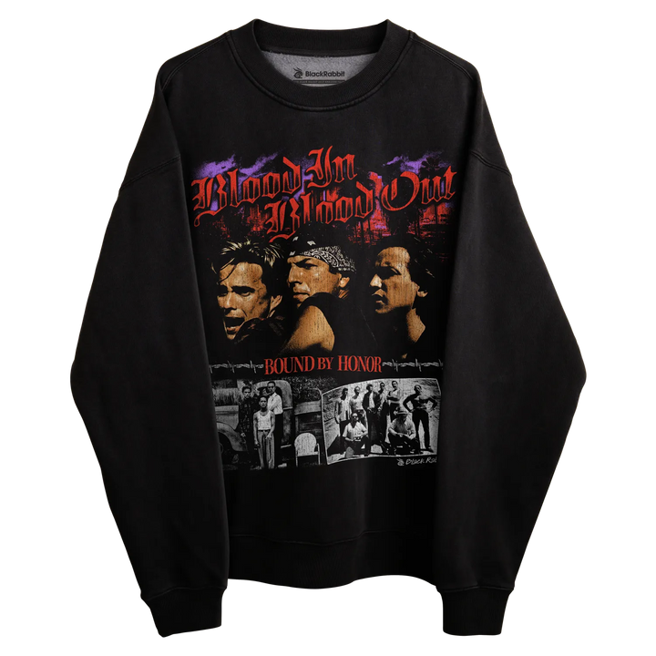 Black sweatshirt with graphic design of ’blood in blood out’ and collage featuring characters in a boxing ring, material appears to be cotton or polyester blend.