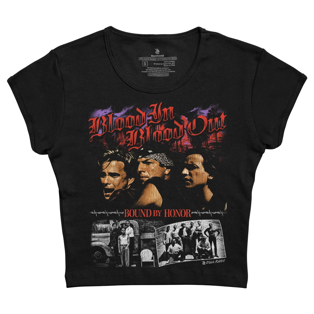 Black short-sleeved t-shirt featuring a graphic print of the movie ’blood in, blood out’ with red and purple lettering above three men’s faces and black-and-white photos below.