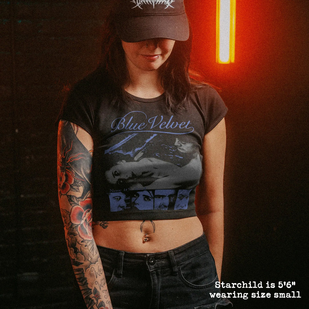Female model wearing cropped baby tee with blue velvet graphic
