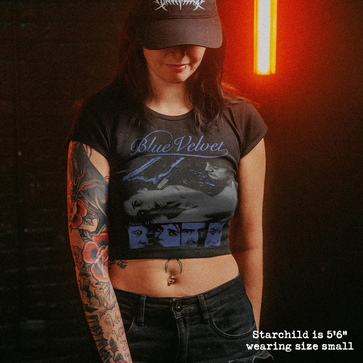 Female model wearing cropped baby tee with blue velvet graphic
