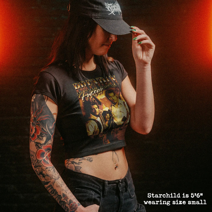 Female model wearing cropped baby tee with brendan fraser graphic
