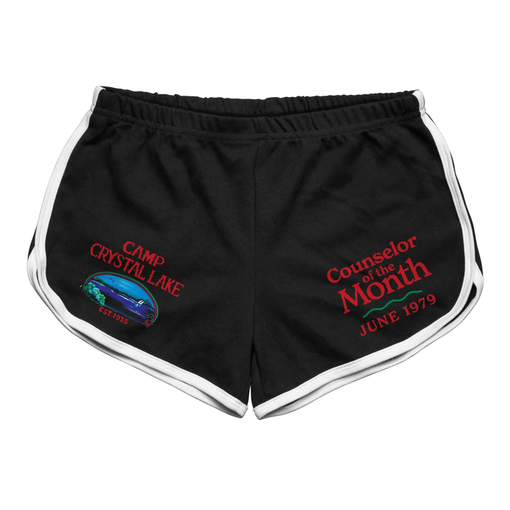 Black athletic shorts with white trim and embroidered graphics reading ’camp crystal lake’ and ’counselor of the month june 1979.’