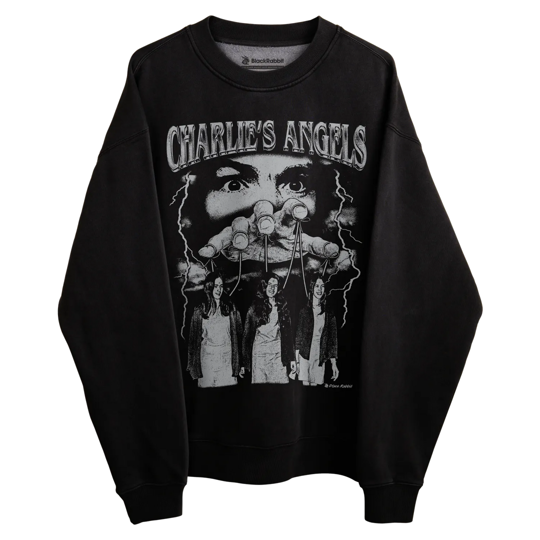 Black long-sleeved sweatshirt with ’charlie’s angels’ graphic design featuring three women and a man, likely made of cotton or polyester blend.
