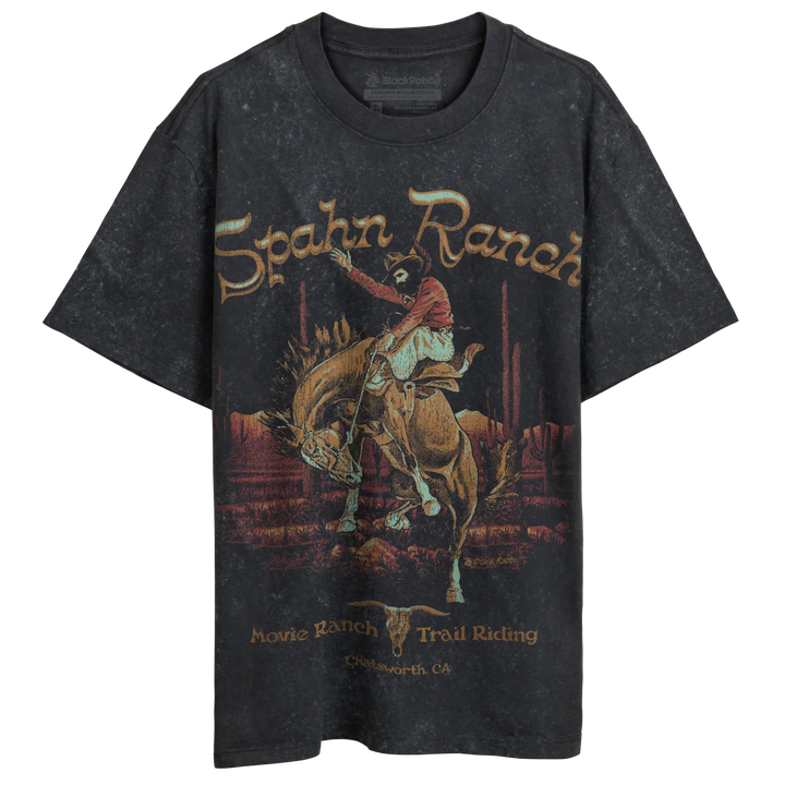 A dark gray, short-sleeved t-shirt with a vintage-style graphic of a cowboy riding a bucking horse in a desert landscape.