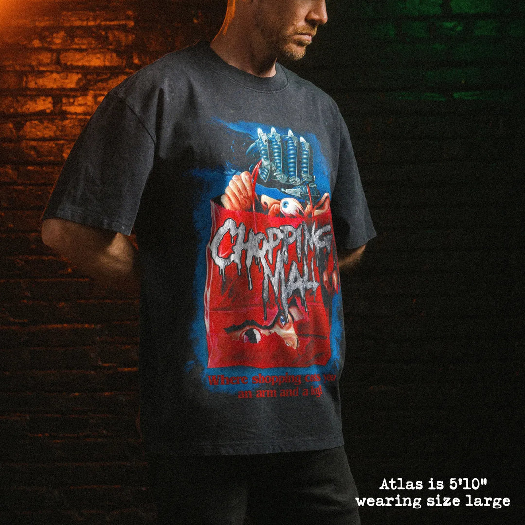 Male model wearing stone wash heavy tee with chopping mall graphic 