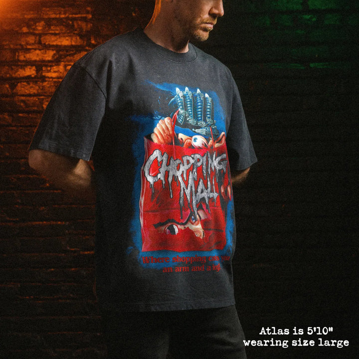 Male model wearing stone wash heavy tee with chopping mall graphic 