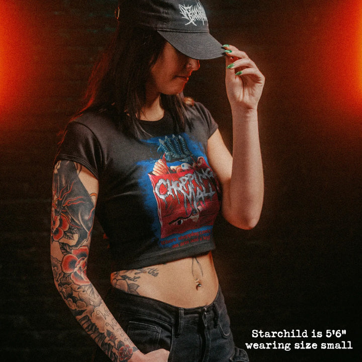 Female model wearing cropped baby tee with chopping mall graphic
