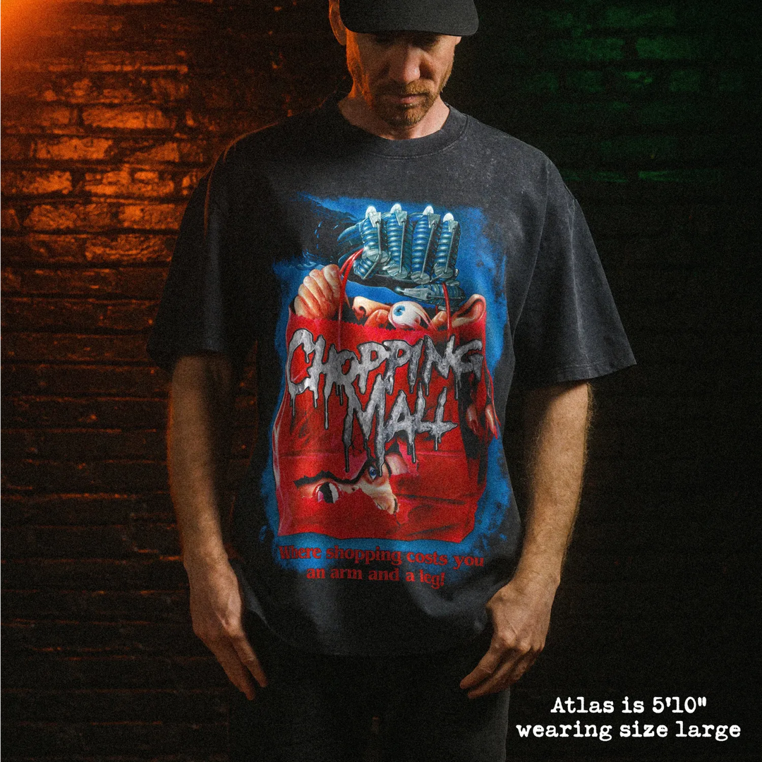 Male model wearing stone wash heavy tee with chopping mall graphic 