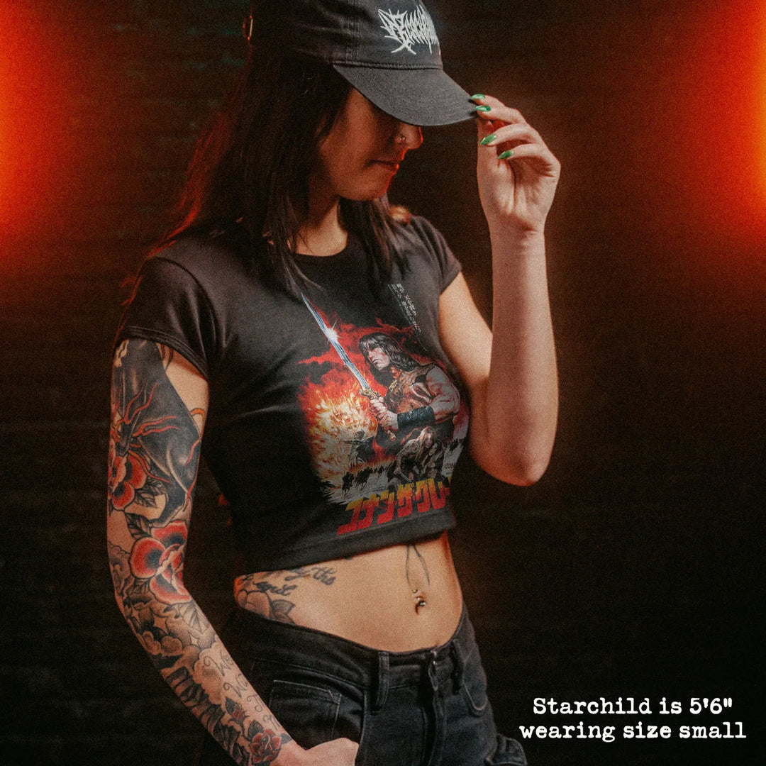 Female model wearing cropped baby tee with conan japan graphic
