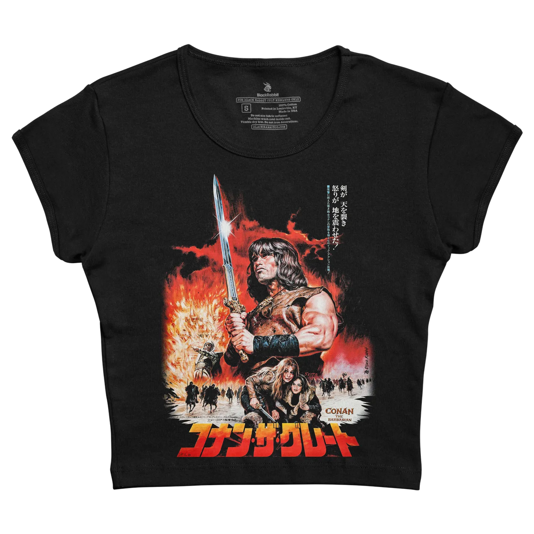 Black short-sleeved t-shirt featuring a vibrant graphic of conan the barbarian holding a sword against fiery background with japanese text and ’conan’ branding.