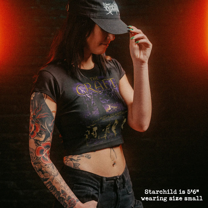 Female model wearing cropped baby tee with the craft graphic
