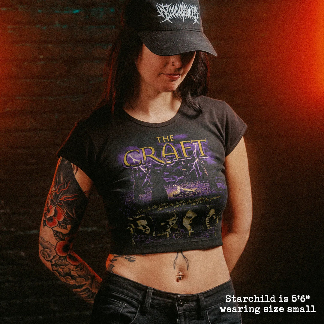Female model wearing cropped baby tee with the craft graphic
