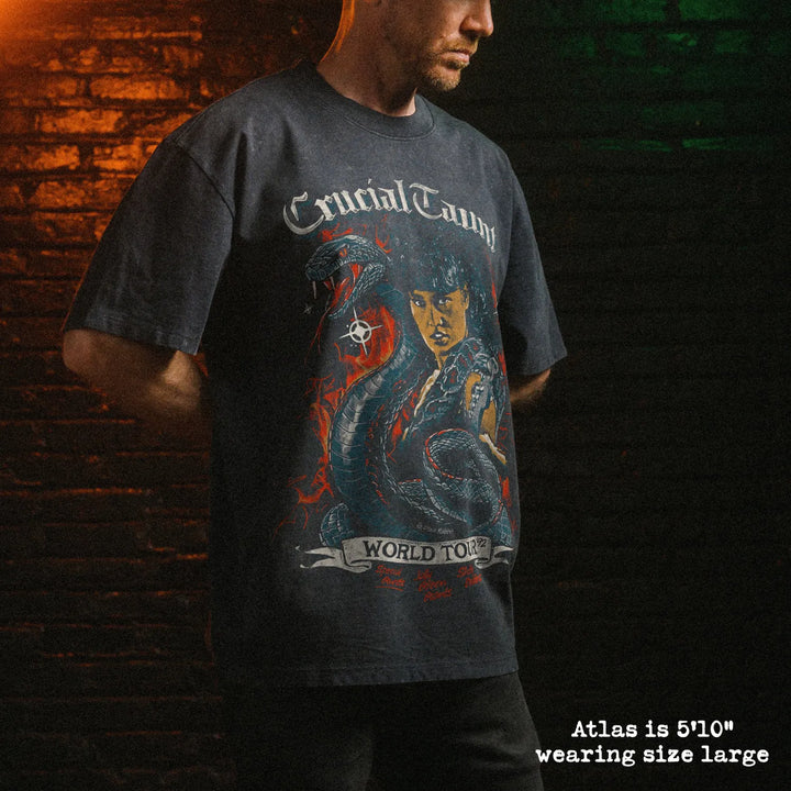 Male model wearing stone wash heavy tee with crucial taunt graphic 