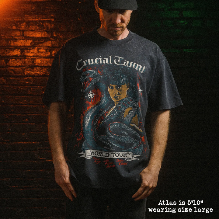 Male model wearing stone wash heavy tee with crucial taunt graphic 