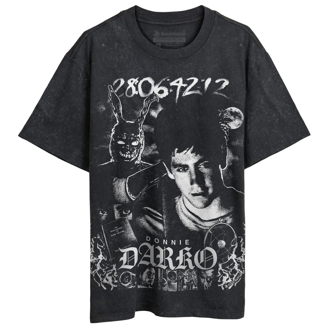 A stone washed graphic t-shirt featuring a distressed white print of Donnie Darko, including a portrait, a rabbit mask, and the text &