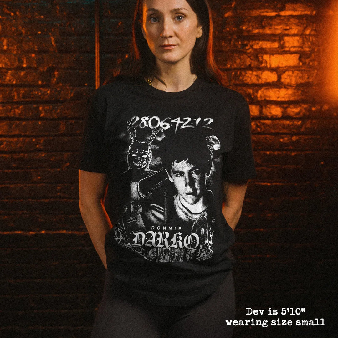 A female model wearing soft premium tee with Donnie Darko graphic 