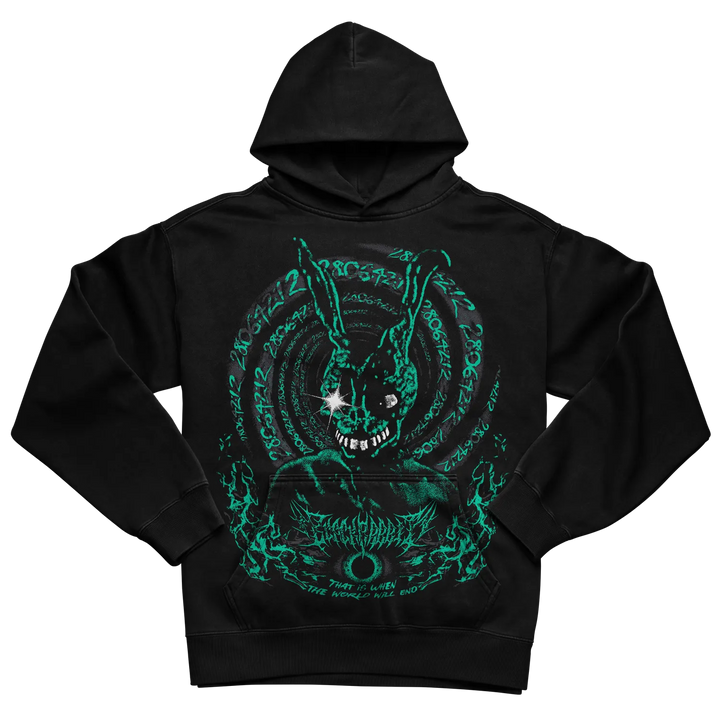 A black pullover hoodie featuring a large, detailed graphic print on the front. The graphic depicts a dark, stylized rabbit-like creature with long ears, glowing white stars in its eyes, sharp teeth, and a circular, psychedelic background filled with swirling patterns and text in a bright neon green color. 