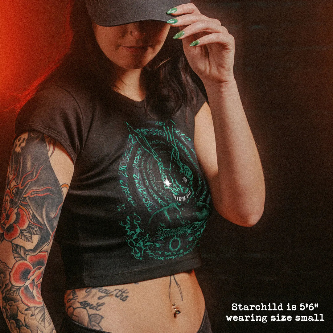 Female model wearing cropped baby tee with Donnie Darko graphic
