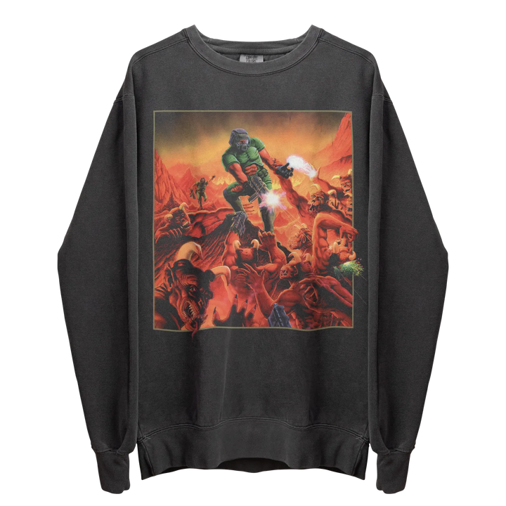 A dark grey long-sleeved sweatshirt featuring a vibrant graphic print of the Doom Slayer surrounded by demons in a fiery landscape.