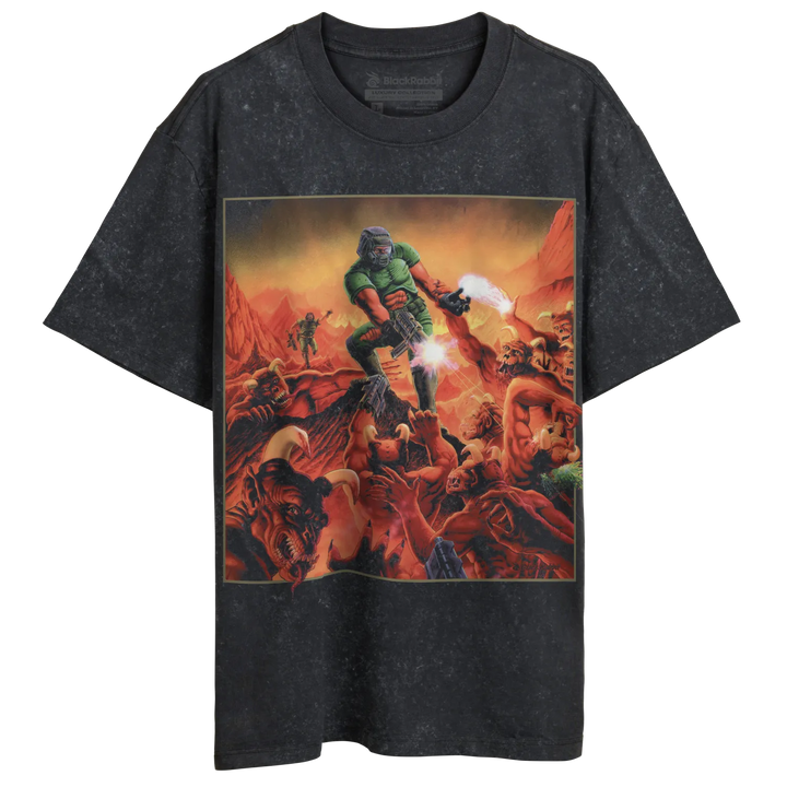 A dark gray t-shirt with a vibrant, action-packed illustration of a green-armored figure battling demons.
