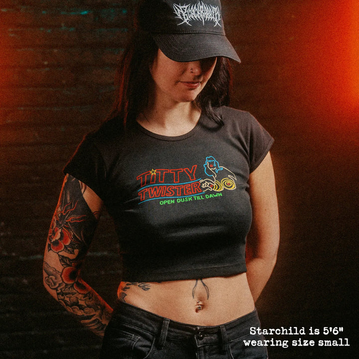 Female model wearing cropped baby tee with titty twister graphic
