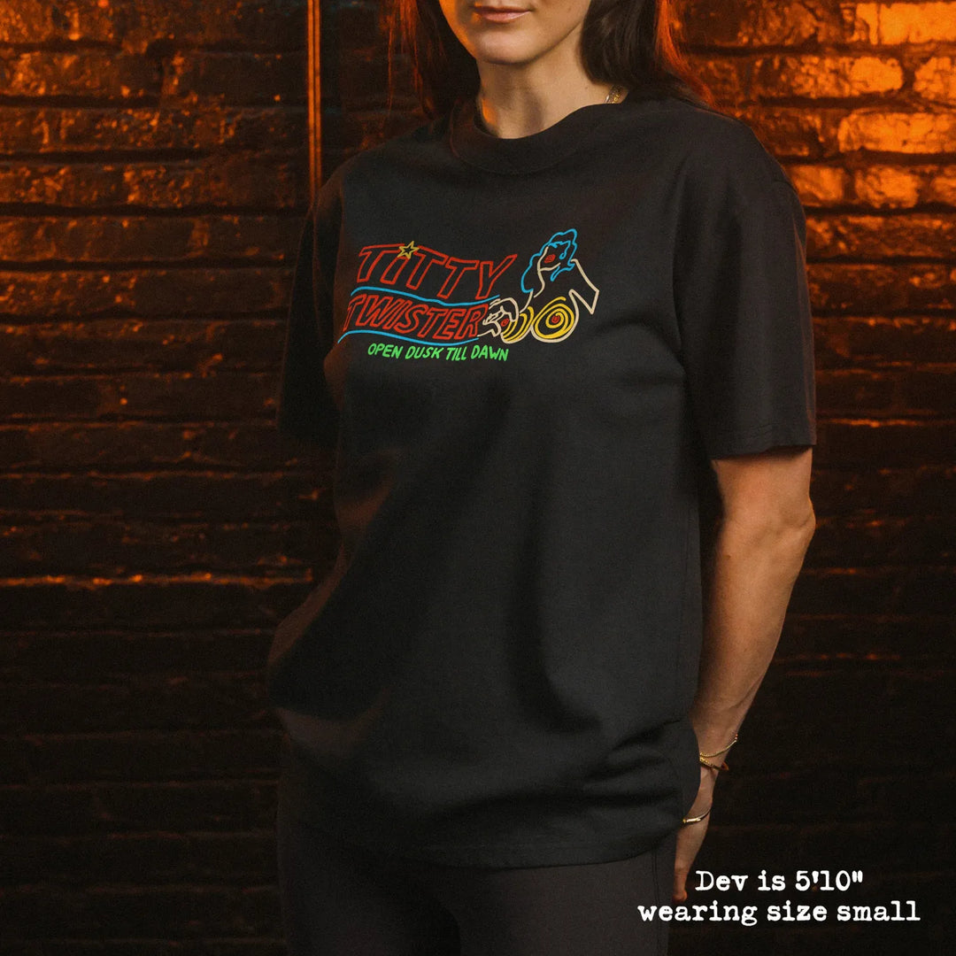 Female model wearing heavy tee with Titty Twister graphic