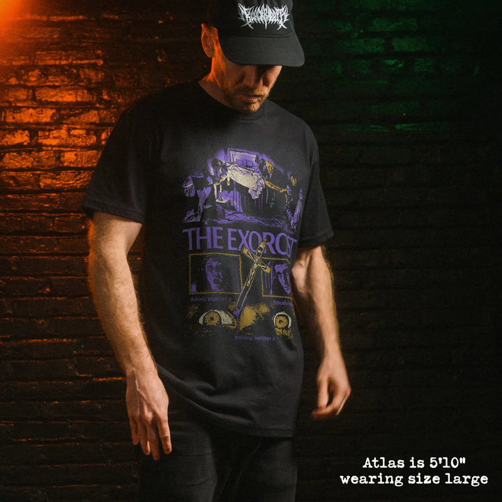 Male model wearing black premium tee with exorcist graphic 