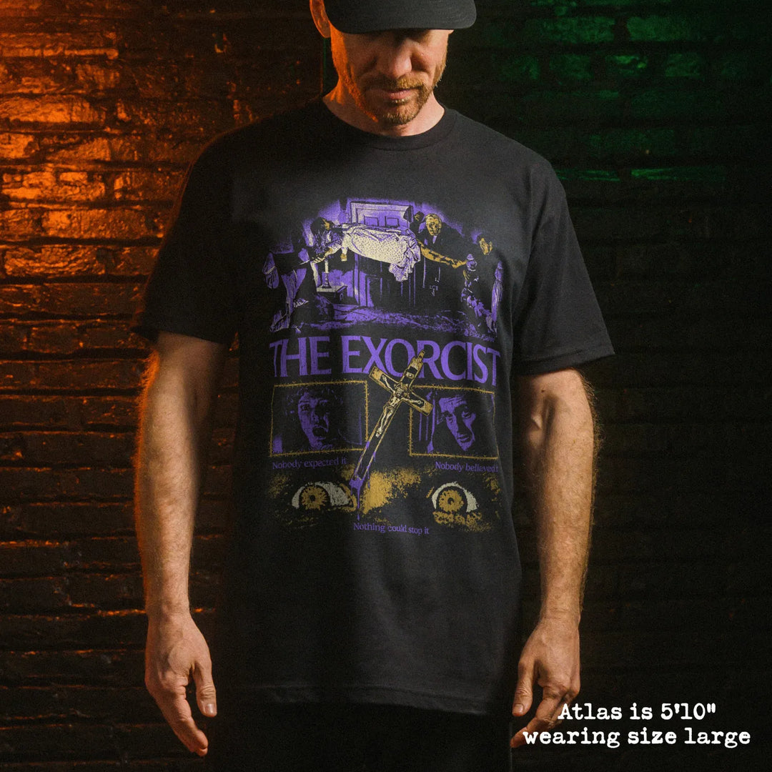 Male model wearing black premium tee with exorcist graphic 