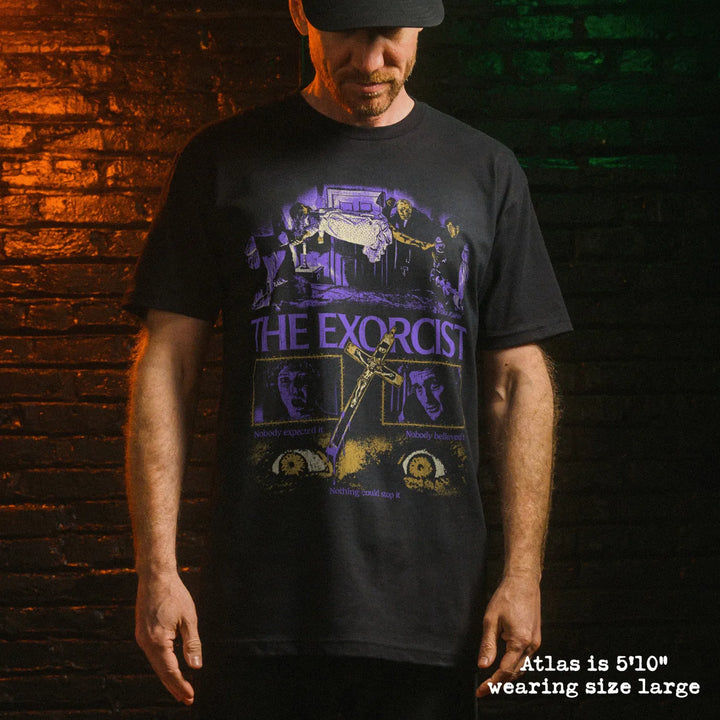 Male model wearing black premium tee with exorcist graphic 